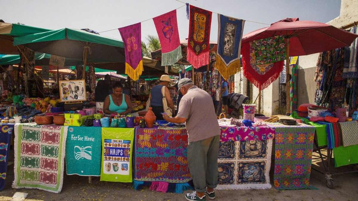 Feira de artesanato ao ar livre com tecidos e cerâmica