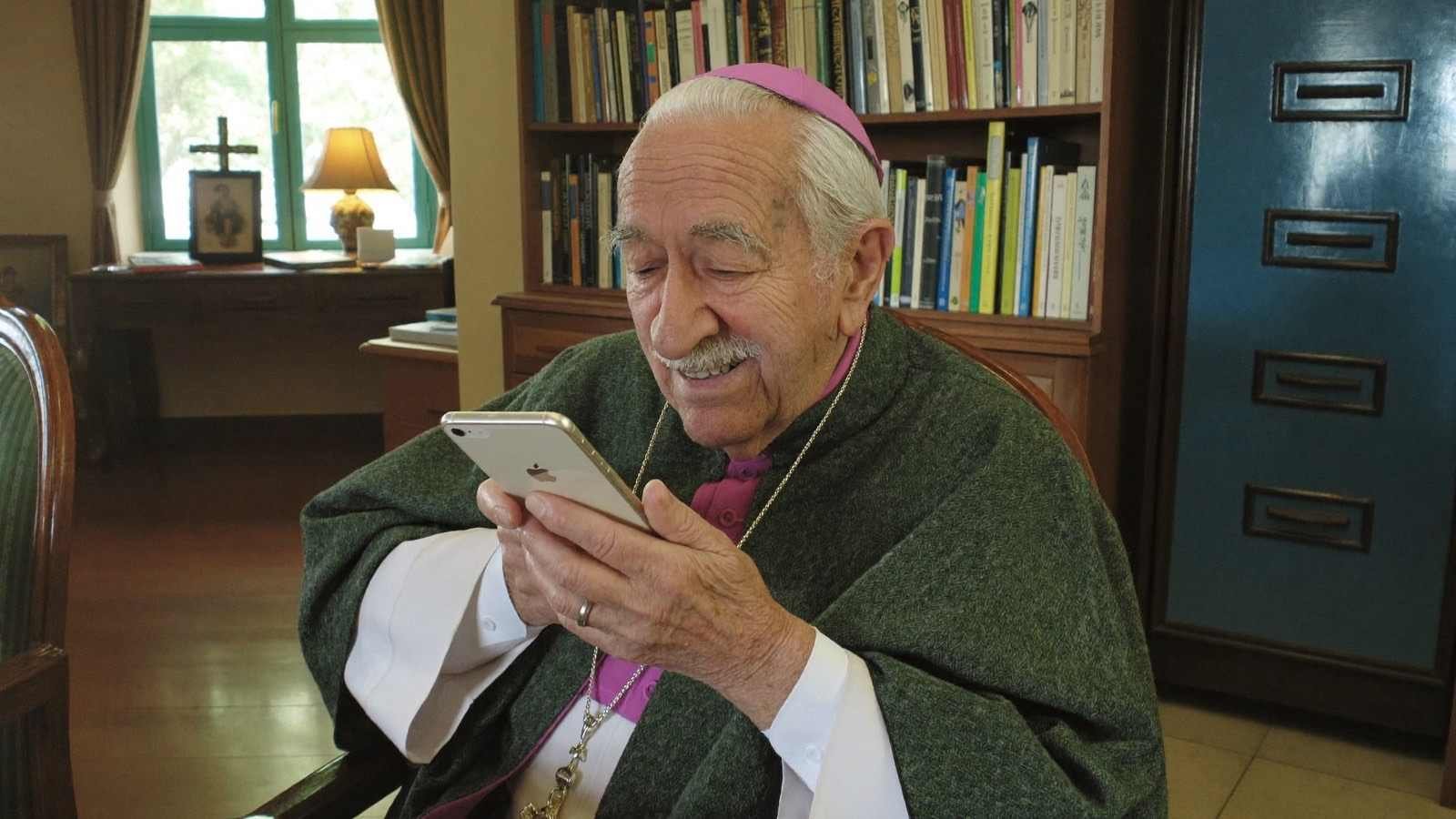 Padre sorrindo ao olhar mensagens no celular