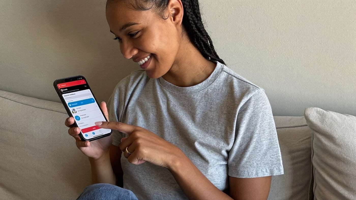 Pessoa sorrindo ao ver notificação de depósito no aplicativo do banco